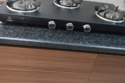 Three-burner black gas stove on a kitchen counter