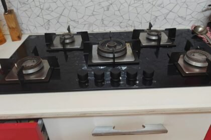 Glen five-burner glass hob with the burners stripped down