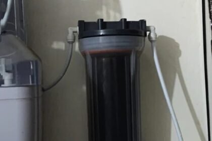 RO pre-filter cartridge black with sediment, before replacement